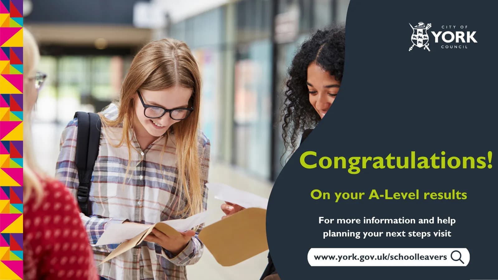 Two young women, one wearing glasses and a plaid shirt, are smiling and looking down at papers as if reviewing exam results, with text overlay congratulating them on A-Level results.