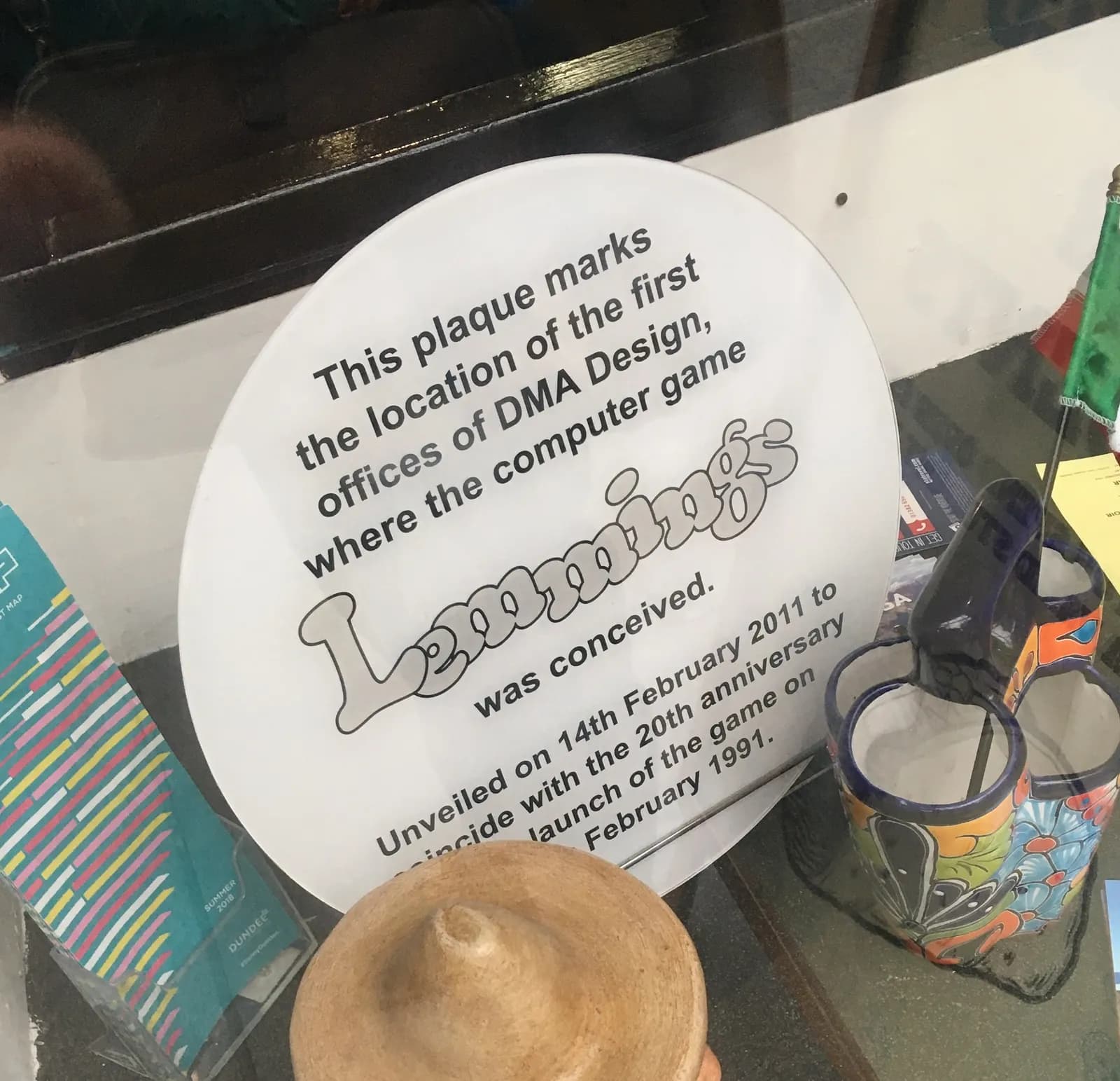 A white circular plaque commemorating the first offices of DMA Design, where the computer game Lemmings was conceived.