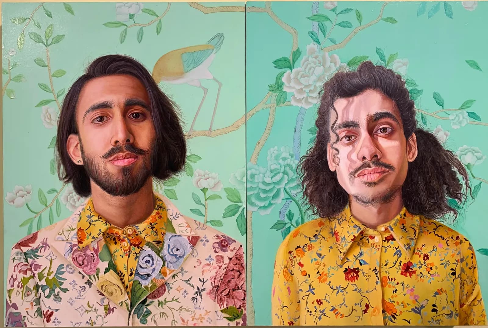 A painting split into two panels, each depicting a man with dark hair, a mustache, and a beard, wearing a floral shirt and jacket, set against a background of light blue wallpaper with white flowers and a bird.