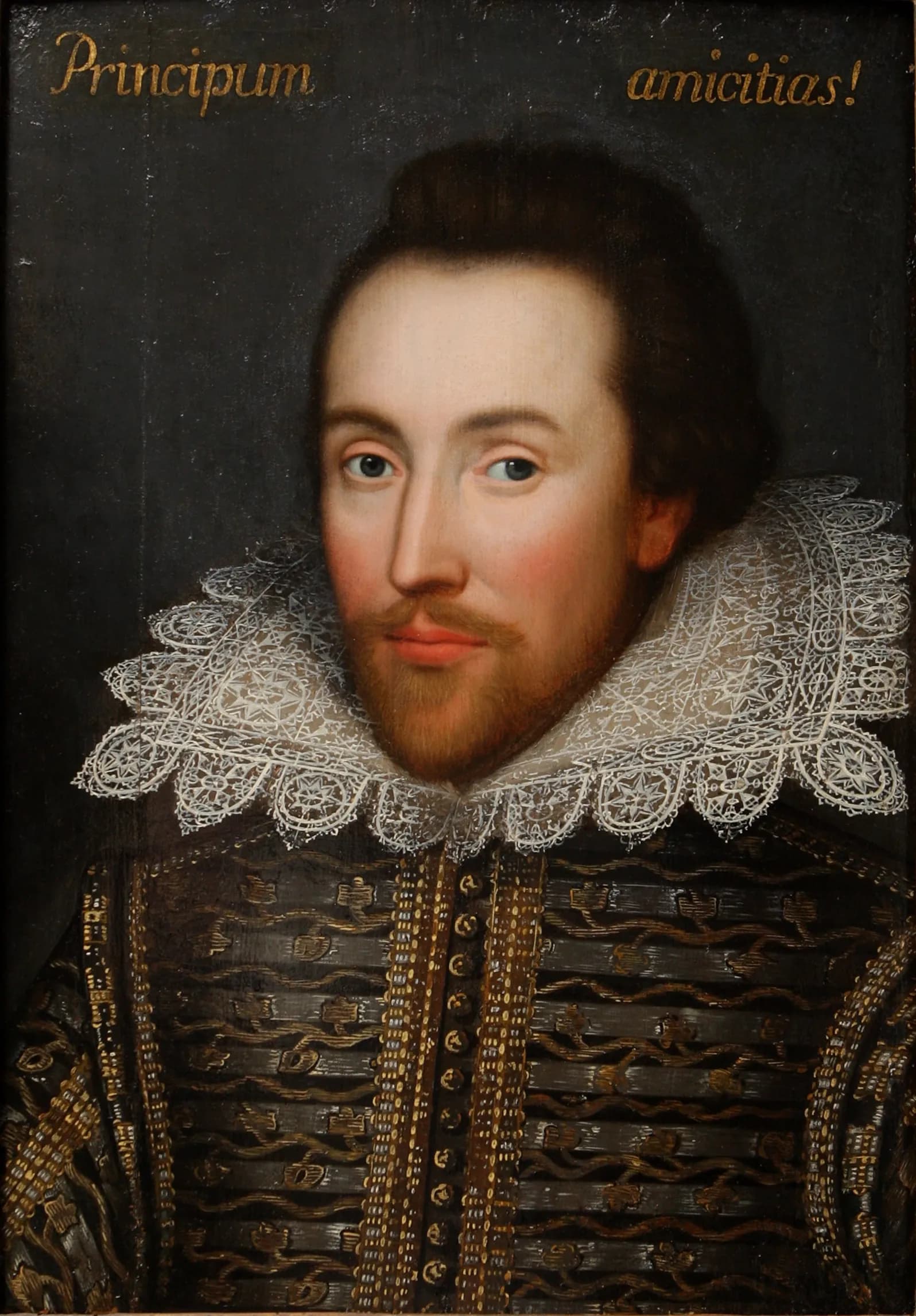 A painted portrait of a man, possibly William Shakespeare, with a beard and mustache, wearing a white lace ruff and an ornate black and gold doublet. Golden text at the top reads "Principum amicitias!".