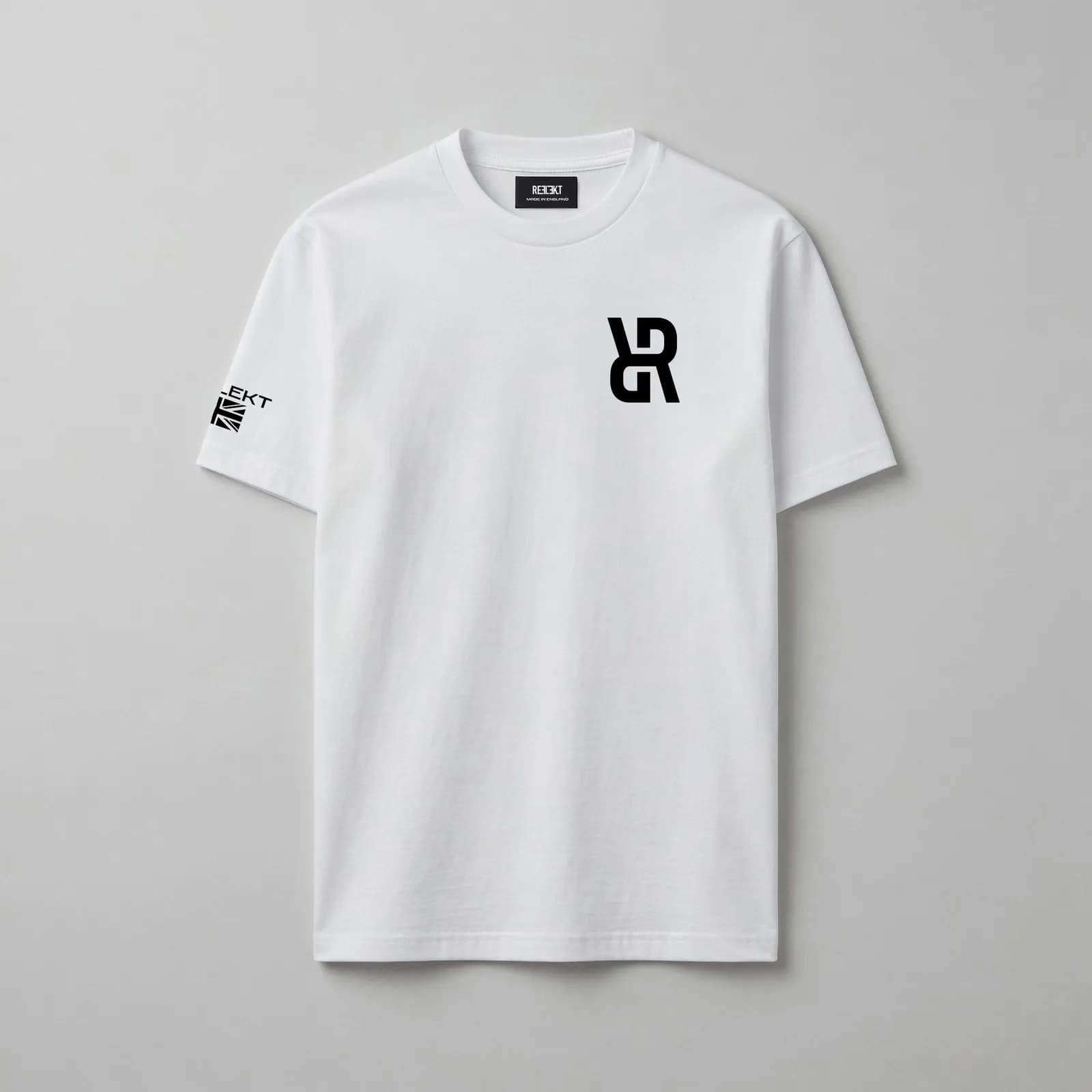 A white t-shirt with a bold black 'R' logo on the chest and a black tag with 'RECKT' written on it.