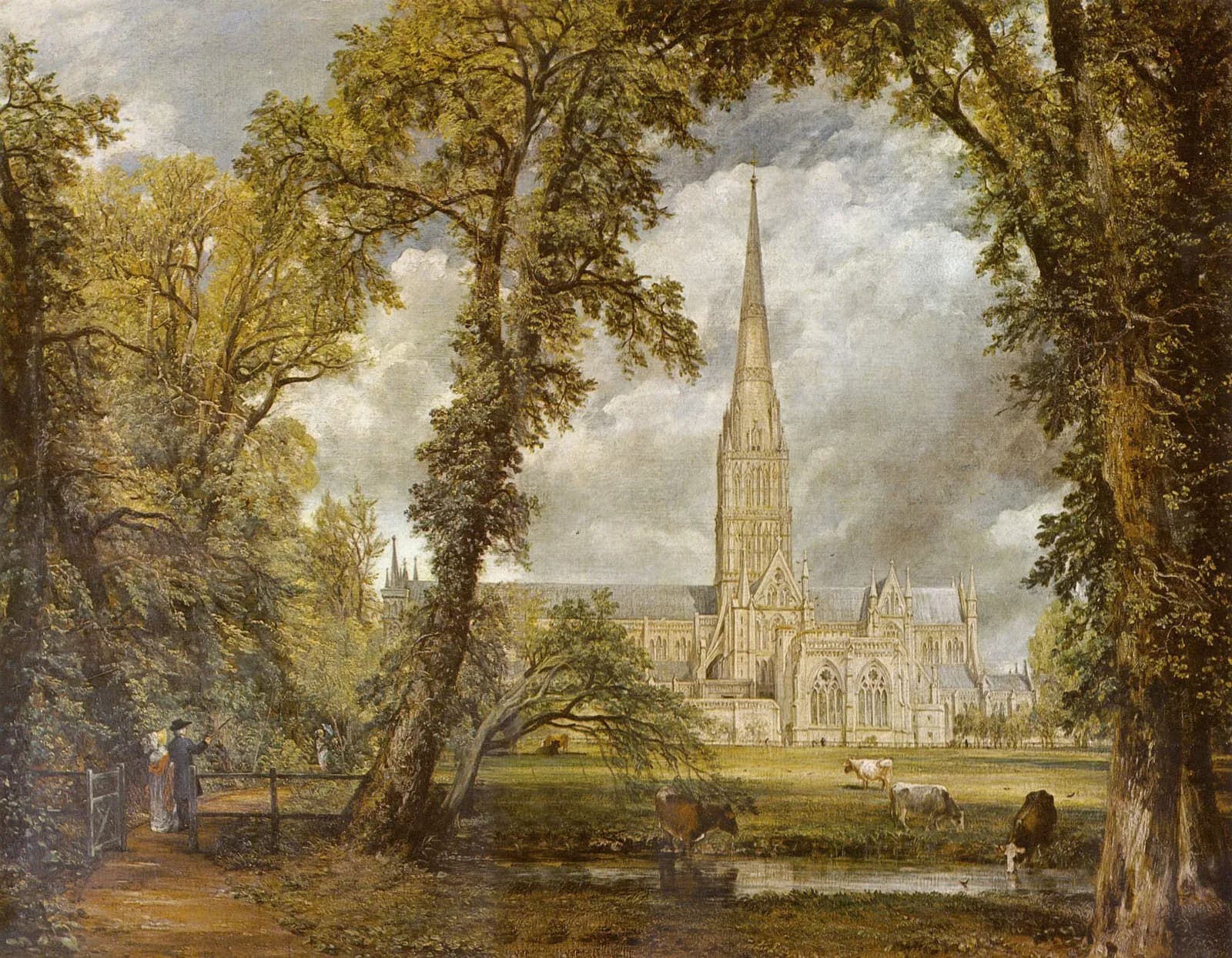 A grand cathedral with a tall spire stands prominently in the background, framed by lush green trees and a field where cows graze near a stream.