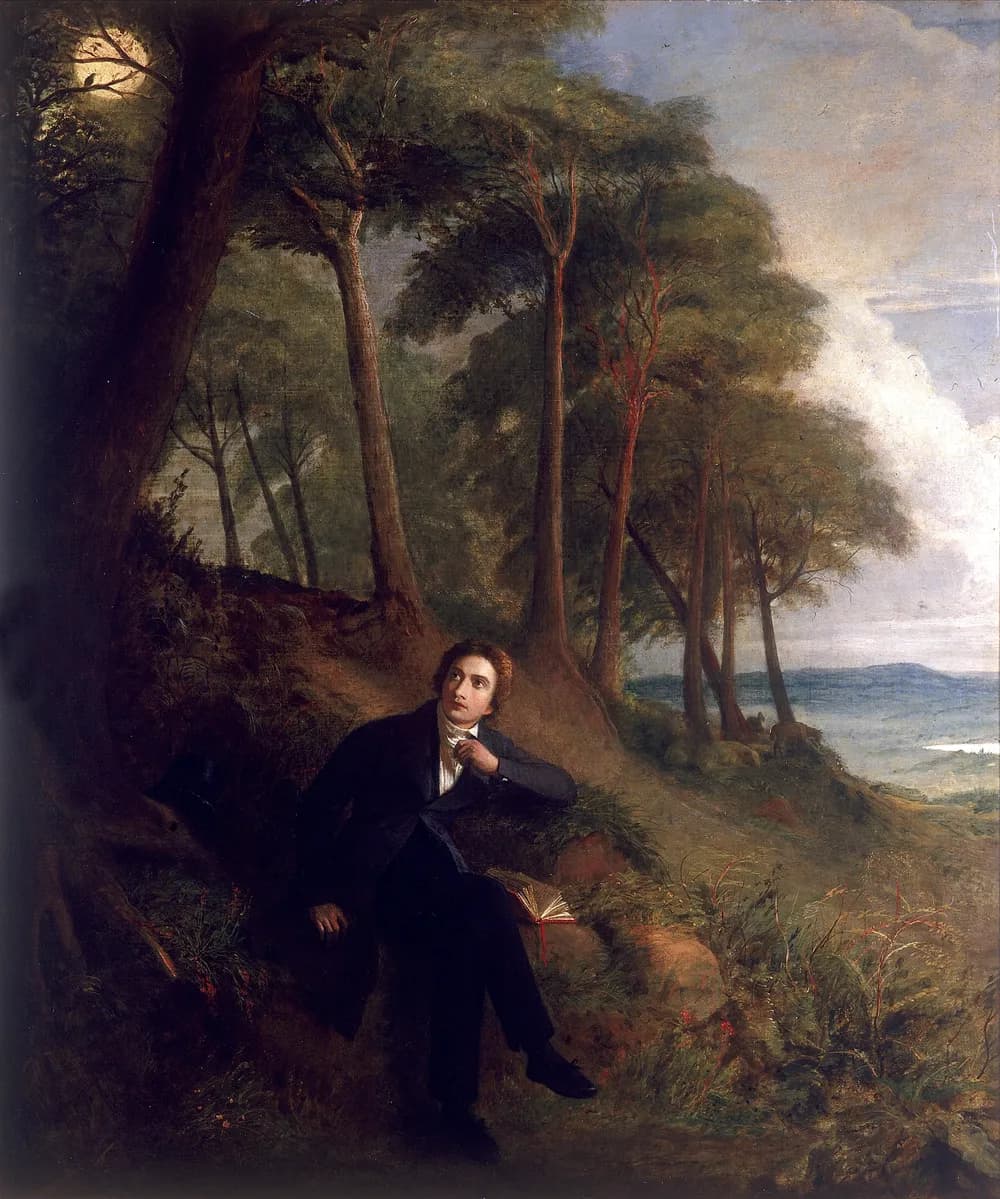 A painting depicts a young man in dark formal attire, seated on a root-covered embankment beneath tall trees, looking upwards towards the moon, with a book nearby and a distant landscape visible.