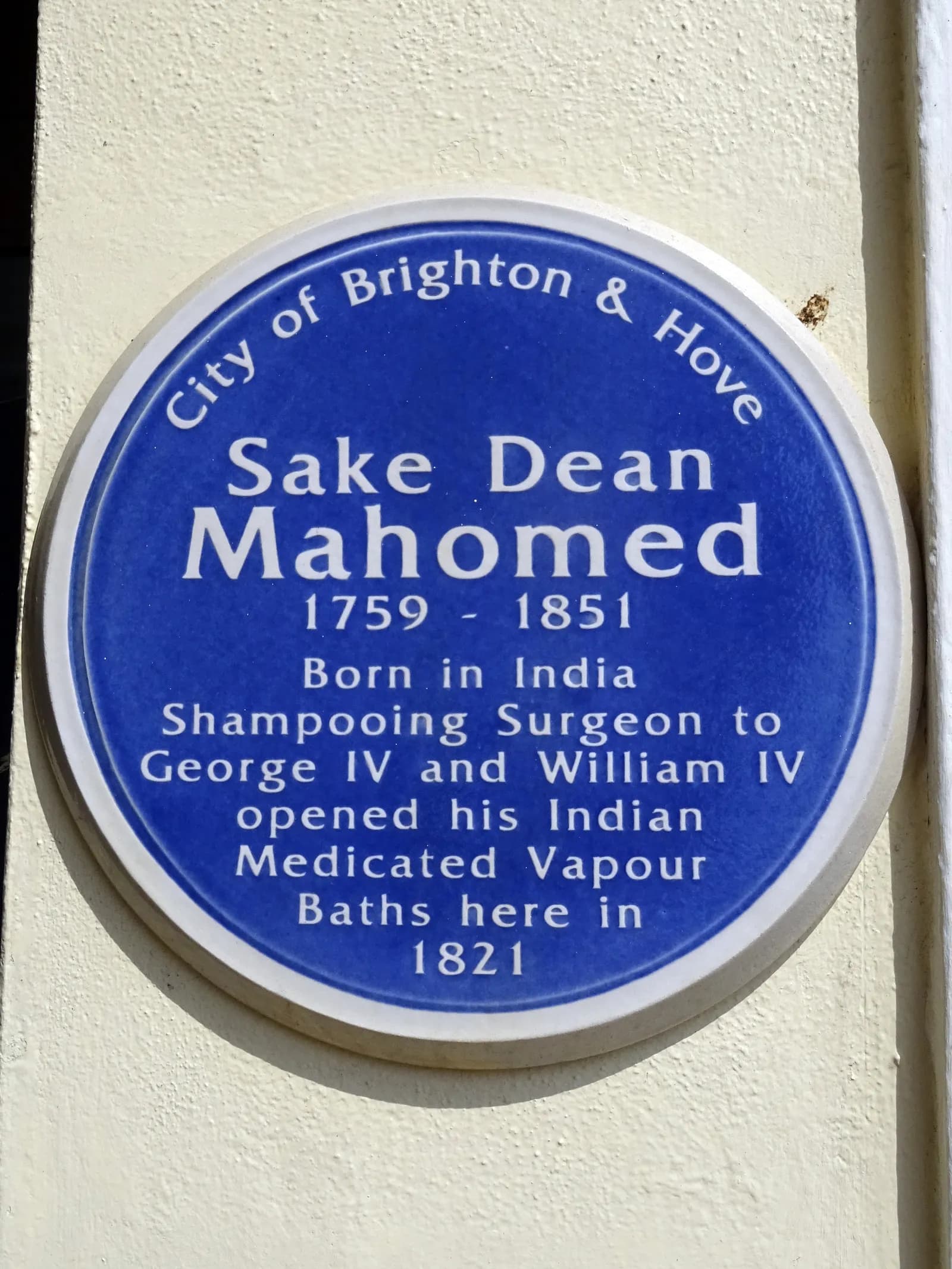 A blue circular plaque from the City of Brighton & Hove commemorating Sake Dean Mahomed, a Shampooing Surgeon who opened Indian Medicated Vapour Baths in 1821.