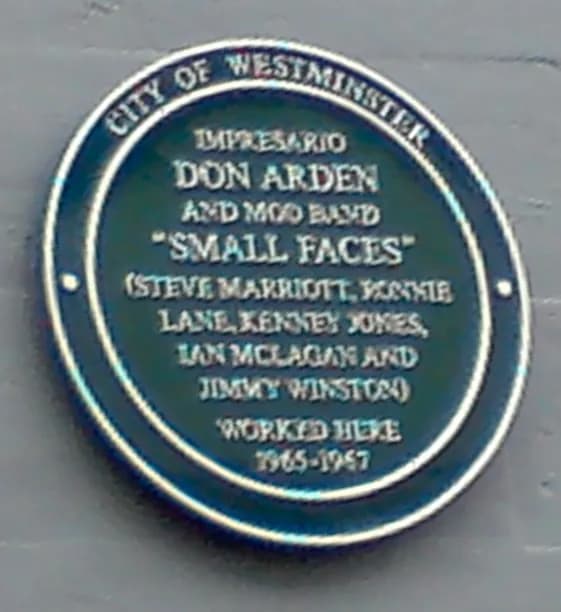 A teal blue plaque with a silver border details that Impresario Don Arden and Mod band "Small Faces" (Steve Marriott, Ronnie Lane, Kenney Jones, Ian McLagan, and Jimmy Winston) worked here from 1965-1967 in the City of Westminster.