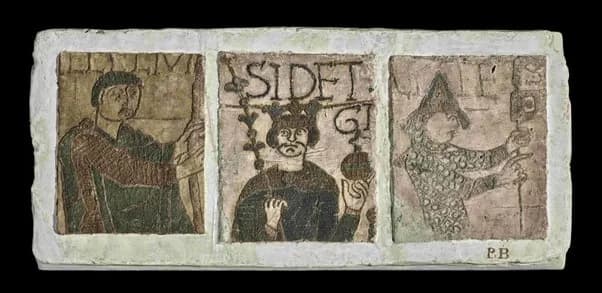 A triptych of three Medieval-style drawings on plaster, depicting a man on the left holding a stick, a crowned king in the center holding an orb, and a man in a pointed hat on the right holding a staff.